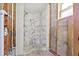 Bathroom featuring a remodeled shower with marble tiling and decorative flooring at 130 81St Ne Ave, St Petersburg, FL 33701