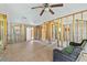 Spacious living room with wood floors, large window, and view into the unfinished walls at 130 81St Ne Ave, St Petersburg, FL 33701