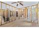 Spacious living room with wood floors and view into the bathroom remodel at 130 81St Ne Ave, St Petersburg, FL 33701