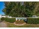 Welcoming community entrance with lush landscaping and decorative signage at 1308 Pine Ridge E Cir # E3, Tarpon Springs, FL 34688