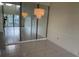 Chandelier lights up dining area with mirrored wall and sliding glass doors at 1308 Pine Ridge E Cir # E3, Tarpon Springs, FL 34688