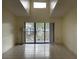 Bright living room with high ceilings and sliding glass doors to balcony at 1308 Pine Ridge E Cir # E3, Tarpon Springs, FL 34688
