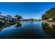 Scenic pond view with a water fountain and surrounding community buildings at 1308 Pine Ridge E Cir # E3, Tarpon Springs, FL 34688