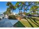 Community pool area features lush landscaping, mature trees, and inviting walkway and plenty of parking at 1308 Pine Ridge E Cir # E3, Tarpon Springs, FL 34688