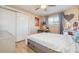 Bedroom features a white bedframe with drawers, side table, closet, and a window providing natural light at 1413 Wisconsin Ave, Palm Harbor, FL 34683