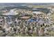 Lush aerial view of a residential area featuring peaceful ponds and natural tree coverage at 15701 Greyrock Dr, Spring Hill, FL 34610