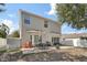 Spacious backyard features a large concrete patio, iron table set, fire pit, and privacy fence at 15701 Greyrock Dr, Spring Hill, FL 34610
