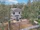 Aerial view of a fenced yard with an outdoor patio featuring dining and entertaining space at 15701 Greyrock Dr, Spring Hill, FL 34610