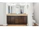 Bright bathroom featuring double sinks with granite counters, tiled floors, and plenty of storage space at 15701 Greyrock Dr, Spring Hill, FL 34610