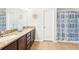 Bathroom boasts double sinks with granite countertops, tiled floors, and neutral finishes for a serene feel at 15701 Greyrock Dr, Spring Hill, FL 34610