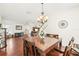 Elegant dining room with hardwood floors and a view of the living room at 15701 Greyrock Dr, Spring Hill, FL 34610