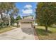 This lovely two-story home boasts a neutral tan exterior with an attached two-car garage and brick-lined driveway at 15701 Greyrock Dr, Spring Hill, FL 34610