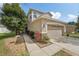 Inviting two-story home with a stone-accented garage and beautifully landscaped front yard at 15701 Greyrock Dr, Spring Hill, FL 34610