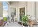 Welcoming front porch area with a decorative wreath, potted plant, and outdoor seating at 15701 Greyrock Dr, Spring Hill, FL 34610