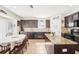 Bright kitchen featuring an island with granite countertop, dark wood cabinets, and an adjacent dining area at 15701 Greyrock Dr, Spring Hill, FL 34610