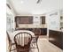 Charming kitchen featuring dark wood cabinetry, granite countertops, a breakfast nook, and tile flooring at 15701 Greyrock Dr, Spring Hill, FL 34610