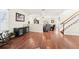 Spacious living room featuring hardwood floors, a staircase, and an open-concept design at 15701 Greyrock Dr, Spring Hill, FL 34610