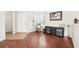 Hardwood floors, white walls, and a decorative chair accent this charming living room at 15701 Greyrock Dr, Spring Hill, FL 34610