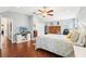 Spacious main bedroom featuring a bed, ceiling fan, and wood floors at 15701 Greyrock Dr, Spring Hill, FL 34610