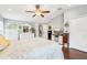 Large main bedroom featuring wood floors, a ceiling fan, television and a spacious layout at 15701 Greyrock Dr, Spring Hill, FL 34610