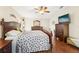 Spacious main bedroom features a ceiling fan, wood floors, and generous closet space for optimal comfort at 15701 Greyrock Dr, Spring Hill, FL 34610