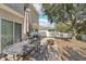 Outdoor patio features an iron table set, umbrella, and sliding glass door access to the home at 15701 Greyrock Dr, Spring Hill, FL 34610