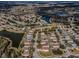 Expansive aerial view showcases a residential community with houses, streets, and serene lakes surrounded by trees and natural beauty at 19609 Timberbluff Dr, Land O Lakes, FL 34638