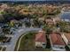 Aerial view of the neighborhood showcasing homes, landscaping, and nearby lake at 19609 Timberbluff Dr, Land O Lakes, FL 34638