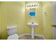 Small bathroom with tile flooring, a pedestal sink, and a toilet at 19609 Timberbluff Dr, Land O Lakes, FL 34638