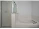 Close-up of the bathroom's soaking tub and shower stall, highlighting modern fixtures and design at 19609 Timberbluff Dr, Land O Lakes, FL 34638