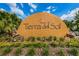 Welcoming entrance sign of Tierra del Sol community surrounded by lush landscaping, rocks, and green shrubs at 19609 Timberbluff Dr, Land O Lakes, FL 34638