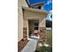 Cozy front porch with stone accents, seating, and a view of the landscaped yard at 19609 Timberbluff Dr, Land O Lakes, FL 34638