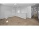 Bright hallway featuring neutral carpet, white walls, and natural light from nearby windows at 19609 Timberbluff Dr, Land O Lakes, FL 34638