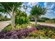 Beautiful landscaping with colorful flowers, trees, and shrubs along the street and features a classic street lamp post at 19609 Timberbluff Dr, Land O Lakes, FL 34638