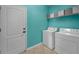Laundry room featuring a washer, dryer, and shelving at 19609 Timberbluff Dr, Land O Lakes, FL 34638