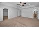 Large main bedroom showcasing a tray ceiling with fan, recessed lighting, carpet, and ensuite access at 19609 Timberbluff Dr, Land O Lakes, FL 34638