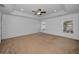 Spacious main bedroom featuring carpet, tray ceiling with fan, recessed lighting and two windows at 19609 Timberbluff Dr, Land O Lakes, FL 34638