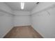 Spacious walk-in closet with carpet and built-in shelving, providing ample storage space at 19609 Timberbluff Dr, Land O Lakes, FL 34638