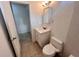 Compact bathroom includes a vanity with storage, a toilet, and a mirrored cabinet at 2401 Bayshore Blvd # 101, Tampa, FL 33629