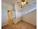 Bright bedroom featuring tile floors, a ceiling fan, and a closet with folding doors at 2401 Bayshore Blvd # 101, Tampa, FL 33629