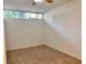 An empty bedroom with tan tiles and a window is shown at 2401 Bayshore Blvd # 101, Tampa, FL 33629