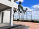 Exterior shot of the building complex near water, complemented by palm trees and greenery at 2401 Bayshore Blvd # 101, Tampa, FL 33629