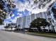 Exterior view of the high-rise building with beautiful landscaping and mature trees at 2401 Bayshore Blvd # 101, Tampa, FL 33629