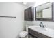 Dark wood vanity and hardware in this bathroom, along with a toilet and towel bar at 2700 Cove Cay Dr # 4-B, Clearwater, FL 33760