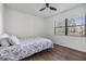 This bedroom has wood floors, a ceiling fan, and a large window at 2700 Cove Cay Dr # 4-B, Clearwater, FL 33760