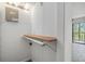 Walk-in closet featuring a wood shelf, pipe and laminate flooring at 2700 Cove Cay Dr # 4-B, Clearwater, FL 33760