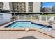 Community hot tub with tiled trim and well-kept pool deck at 2700 Cove Cay Dr # 4-B, Clearwater, FL 33760
