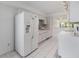 Bright kitchen area featuring a window for natural light and a modern refrigerator at 2700 Cove Cay Dr # 4-B, Clearwater, FL 33760