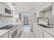 Updated kitchen with white cabinets, modern appliances, and a stylish backsplash at 2700 Cove Cay Dr # 4-B, Clearwater, FL 33760