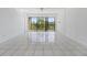 Bright living room with sliding doors to balcony and tile flooring at 2700 Cove Cay Dr # 4-B, Clearwater, FL 33760